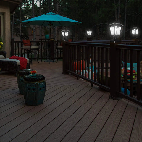 Outdoor Solar Powered Post Cap Lights For 4x4 Wood Posts illuminating a deck with seating area, showing classic lantern style in use.