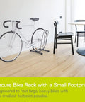 Side view of Two Pack Adjustable Floor Bike Stands For Mountain, Fat Tire And Road Bikes, holding a road bike in a room.