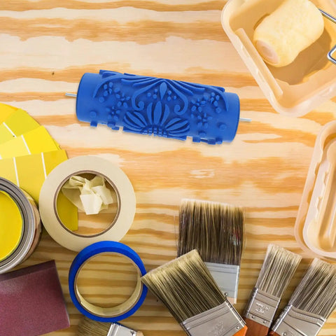 Professional Grade Rubber Pattern Paint Roller For Wall Embossing Featuring Slick Knockout Textures on a workshop table with paint supplies.