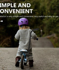 Child biking with Kids Bike Safety Trainer Handle And Balance Push Bar For Parents To Guide Training on wooded path.