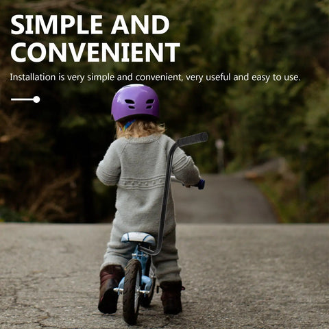 Child biking with Kids Bike Safety Trainer Handle And Balance Push Bar For Parents To Guide Training on wooded path.