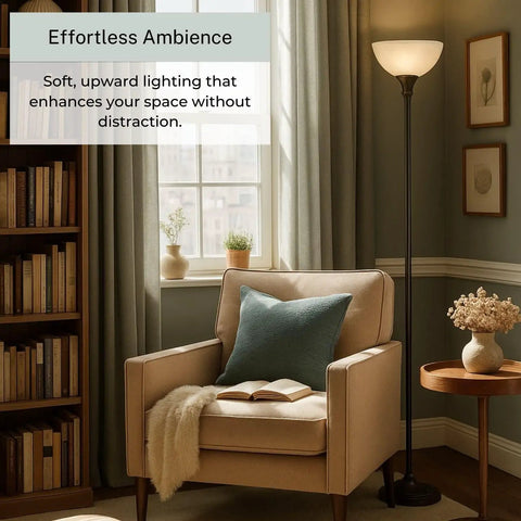 Bronze 72 Inch Torchiere Floor Lamp With Glass Shade in cozy living room corner next to armchair and bookshelf.