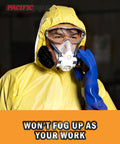 Person wearing safety gear, including respiratory mask and goggles, for industrial protection