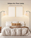 Arched LED Floor Lamp With Beige Linen Shade Slick Modern Mid Century Standing Lamp Black Finish Built In Footswitch Ideal For Living Room Bedroom Study Or Office E26 Base Socket Bulb Not Included Durable Steel Construction next to bed in styled bedroom setting