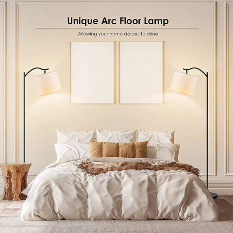 Arched LED Floor Lamp With Beige Linen Shade Slick Modern Mid Century Standing Lamp Black Finish Built In Footswitch Ideal For Living Room Bedroom Study Or Office E26 Base Socket Bulb Not Included Durable Steel Construction next to bed in styled bedroom setting