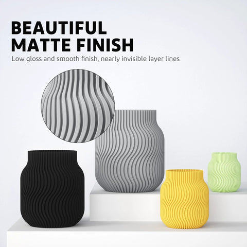 Front view of matte-finish ribbed vases in black, gray, yellow, and lime green on a white platform