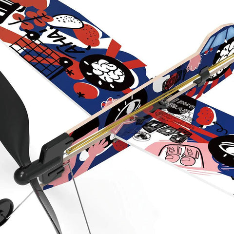Close-up of colorful patterned wing of Rad Rubber Band Airplane Kit With Low Wing Design For STEM Learning Indoor Outdoor Flight Project Includes Step By Step Learning Booklet And Display Stand No Batteries Required Great For Ages 14 Plus.