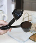 Hand holding EZ Scoop Coffee Scooper And Funnel For Reusable K Cup Pods, Two Tablespoon Capacity, Mess Free Scoop And Dispense