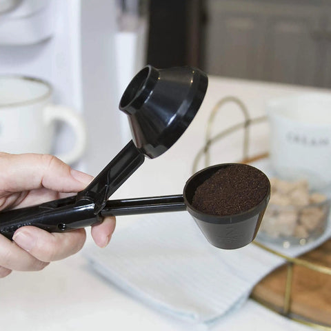 Hand holding EZ Scoop Coffee Scooper And Funnel For Reusable K Cup Pods, Two Tablespoon Capacity, Mess Free Scoop And Dispense