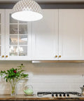 Modern kitchen with cabinets featuring Antique Brass Round Cabinet Knobs 6 Pack, 0.95 inch diameter, zinc alloy construction.