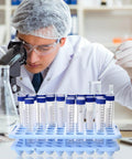 Lab technician using microscope with Six Pack Plastic Test Tube Holder Rack With Silicone Pad For 5 10 15 Milliliter Tubes 18 mm Hole Diameter 50 Holes Detachable Blue Lab Storage Organizer For Your Bench in foreground