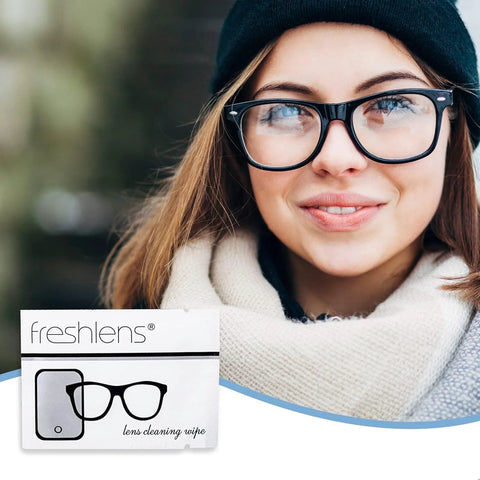 Freshlens lens cleaning wipe packet in foreground; woman wearing black-framed glasses (front view).