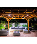 Outdoor pergola with wooden structure, featuring Mission Collection ZMAX Black Powder Coated 90 Degree Angle for 6X Lumber brackets.