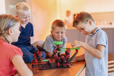 Children enjoying the Dynamic XM Construction Set Multi with 280 Parts for Marble Run Builds, featuring rotary funnel and launch pad.
