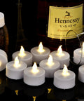 Battery Operated Flameless LED Tea Lights 24 Pack Realistic Flicker Votive Candles with warm white ambience on a table setting