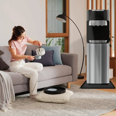 Person pouring water next to dispenser with non-slip silicone water cooler mat with raised edge for floor protection 22x19 inches