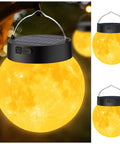 Lit 3D Moon Globe Solar Garden Lights 2 Pack With Warm White LEDs Waterproof Outdoor Decor hanging on tree at night