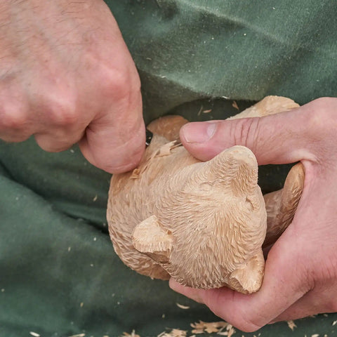 Person carving bear figure from basswood for DIY crafts with 12 Pack Unfinished Basswood Carving Blocks Kit Rectangular Wooden Blocks For Diy Carving Crafts And Whittling 4 By 1 By 1 Inch Blocks For Adults Beginners And Experts Smooth Burr Free Non Toxic Natural Wood.