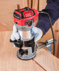 Person using Beefy Compact Wood Router With 6.5 Amp 1.25 HP Power, Fixed Base, Includes Trim Bits, Six Variable Speeds on wood surface