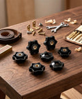 Twenty Count One Quarter Twenty Thread Star Knobs Durable Nylon Thumb Screws With Solid Brass Insert arranged on a wooden table.