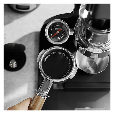 Premium Double Layer Reusable Espresso Shower Screen Filter For 51mm Portafilter Plus 304 Stainless Steel Bottomless Filter Kit held above espresso machine.