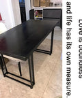 Adjustable Steel Desk Legs Set Of Two supporting a black table, heavy duty iron construction for DIY furniture upgrades.