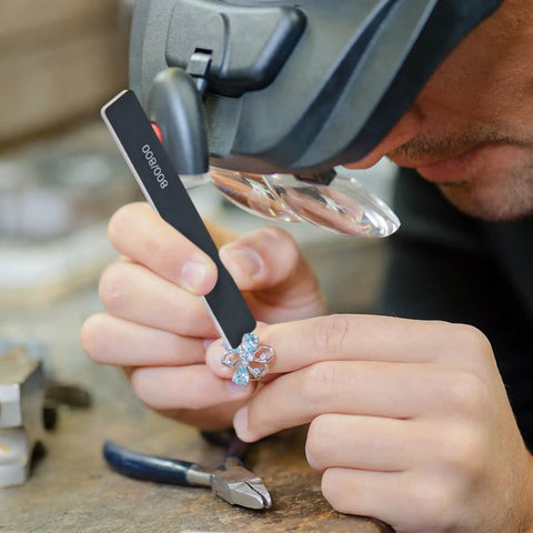 Person using a stick from 40 Pcs Polishing And Sanding Sticks For Metal Wood Plastic Models Buffing Kit on a small object