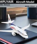 Malaysia 1/400 Scale Airplane Model Kit, alloy body with plastic base, displayed on notebook, no assembly required.