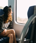 Underseat Go To Carry On Backpack Fits United Airlines 17x10x9 Inches 25L Max Capacity Black Travel Bag beside woman on train