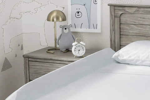 Bedroom with wooden headboard and nightstand, featuring bear-themed decor and a clock, ideal for using the Extra Long Foam Bed Rail For Toddlers And Kids, Water Resistant, Non Slip Guard With Machine Washable Cover, 1 Pack, White, Keeps Little Sleepers Safe From Rolling Out Of Bed, Portable Easy Unroll Design, Cozy Bedtime Shield.