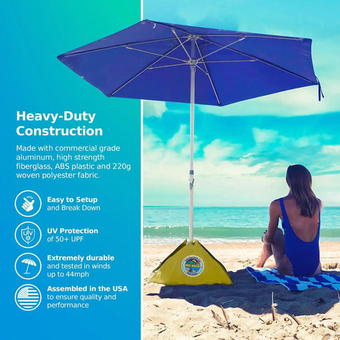 All-In-One Beach Umbrella System With Ultra Base Deep Ocean Blue Seven Point Five Foot Canopy on sandy beach near ocean