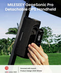 Holding the GeneSonic Pro Golf Speaker with Detachable GPS Rangefinder, outdoor view.