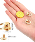 Hand displaying Leather Craft Hardware Kit 12 D Rings And 360 Degree Rotatable Brass Ball Studs For Purses Wallets And Crossbody Straps