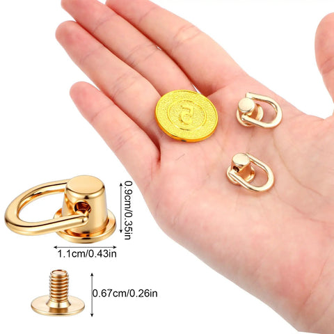 Hand displaying Leather Craft Hardware Kit 12 D Rings And 360 Degree Rotatable Brass Ball Studs For Purses Wallets And Crossbody Straps