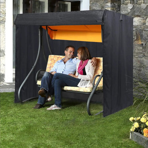 All Weather Yard Saver Swing Cover For Three Seaters And Garden Hammocks in black, protecting swing with seated couple outdoors
