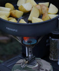 Ultralight Backpacking Stove With Portable Jet Burner for Propane Camp Cooking, heating a pan of potatoes outdoors