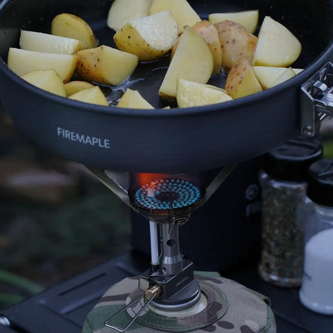 Ultralight Backpacking Stove With Portable Jet Burner for Propane Camp Cooking, heating a pan of potatoes outdoors