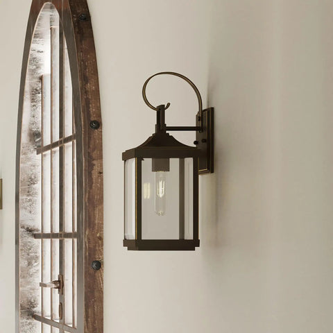 Two Light Outdoor Wall Lantern in Antique Bronze with Clear Beveled Glass on white wall, side angle view, 7 x 21.75 x 8.75 inches