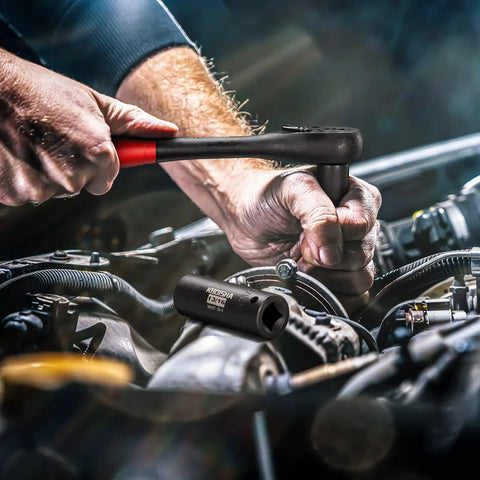 Mechanic using Half Inch Drive Master Impact Socket Set For Heavy Duty Wrenching on car engine, showing hand and tool detail.