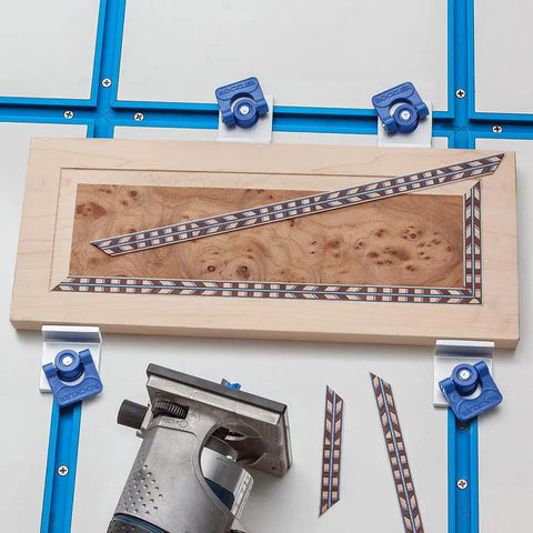 Woodworking with Four Pack Aluminum T Track Stop Kit on 5/8 Inch T-Track, hold down clamps, and a decorated wood panel.