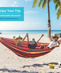 Family relaxing on a Durable 320G Canvas Camping Hammock With 550Lbs Capacity Upgraded Thick Fabric Anti Roll Design at the beach