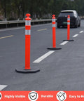 Real McCoy Heavy Duty Traffic Delineator Posts With Weighted Rubber Bases And Bright Reflective Strips For Parking Lot Safety Markers Road Construction Warning Stakes 42 Inch Tall Six Pack Built Tough on road with orange color.