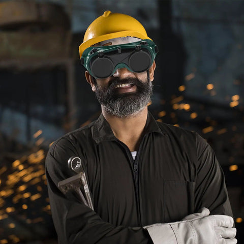 Built Like A Tank Welding Safety Goggles on man with yellow hard hat, showing serious protection in workshop environment.