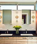 Mid Century Brass Glass Rod Wall Sconces With Two Lights Vanity Light Fixtures in modern bathroom with mirrors and sinks.