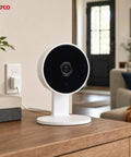 Rock Solid 1080P HD Indoor Security Camera 40 Pack Including Slick White Housing And Extra 32GB Storage Card mounted on a wooden table.