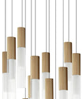 Slick Modern 12-Light Pendant Ceiling Lamp With Top Shelf Gold Finish And Aluminum Build Featuring Clear Ribbed Glass For Your Kitchen Island Or Dining Room Plus Straight Up Adjustable Cord hanging from ceiling with ribbed glass shades.