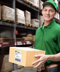 Person in green uniform holding a box with a Genuine 4x6 Direct Thermal Shipping Label For Nelko PL70E Printer in a warehouse.