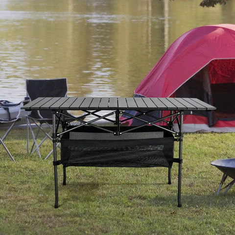 Lightweight Aluminum Folding Camping Table With Portable Roll Up Design For Outdoor Dining On The Go, set up near a lake by red tent.
