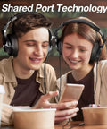 Two people wearing Dual Mode Bluetooth Over Ear Headphones With 72 Hour Battery Life, listening together via shared port technology.