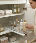 Smooth As Silk Drawer Slides Two Pack No Drill Pull Out Rails For Cabinet Organizers adjustable rail with items in a bathroom cabinet.